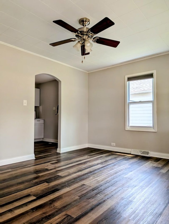 1514 173rd St, East Hazel Crest, IL 60429 - unfurnished room featuring arched walkways, crown molding, dark wood-style flooring, a ceiling fan, and baseboards