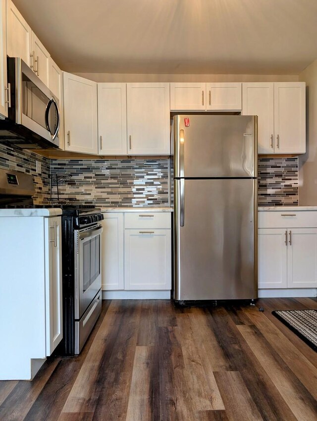 1514 173rd St, East Hazel Crest, IL 60429 - kitchen featuring stainless steel appliances, decorative backsplash, white cabinetry, and dark wood-style floors