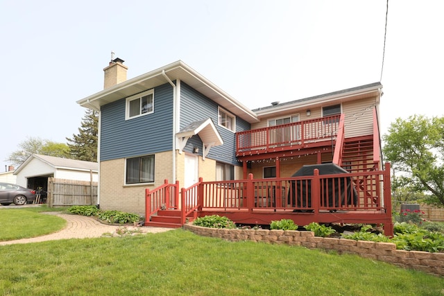 rear view of property featuring a chimney, a yard, a deck, and brick siding