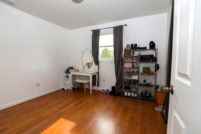 office area featuring wood finished floors, visible vents, and baseboards