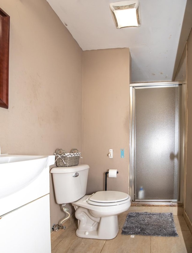 full bath featuring vanity, toilet, a shower stall, and tile patterned flooring