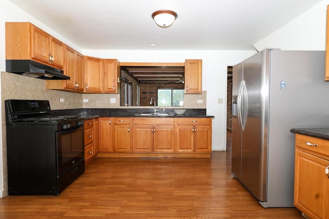18557 W Country Ln, Grayslake, IL 60030 - kitchen featuring black gas stove, under cabinet range hood, a sink, stainless steel refrigerator with ice dispenser, and wood finished floors