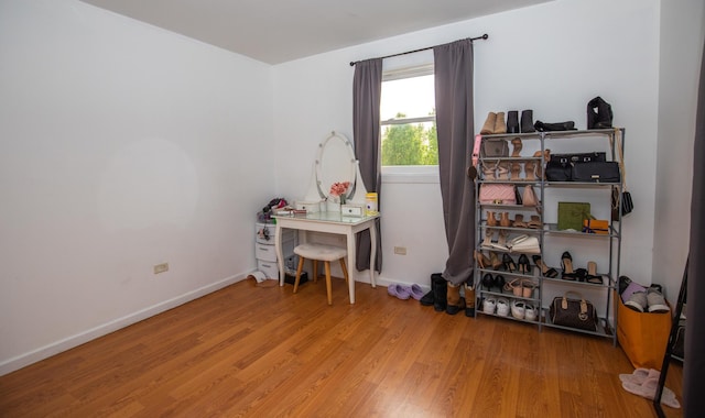 misc room with wood finished floors and baseboards