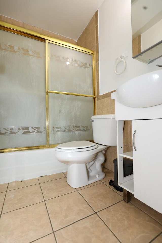 18557 W Country Ln, Grayslake, IL 60030 - full bathroom with tile walls, shower / bath combination with glass door, toilet, vanity, and tile patterned flooring