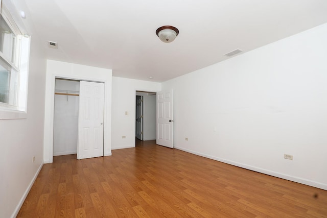 18557 W Country Ln, Grayslake, IL 60030 - unfurnished bedroom with light wood finished floors, baseboards, and a closet