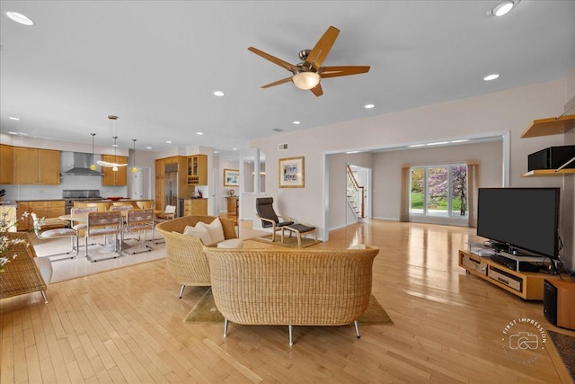 living area with a ceiling fan, recessed lighting, light wood-style flooring, and visible vents