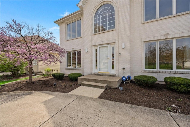 property entrance featuring brick siding