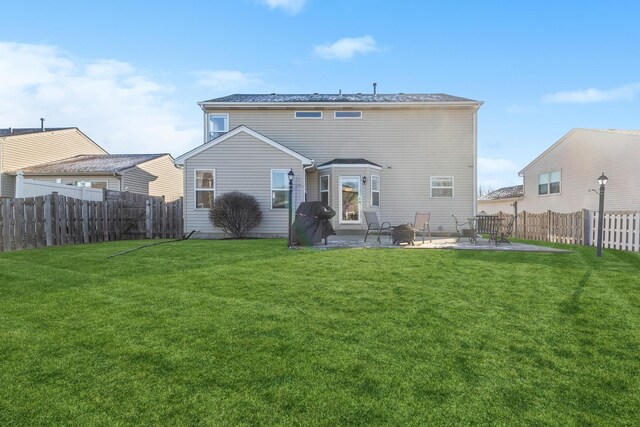 2851 Briarcliff Ln, Lake In The Hills, IL 60156 - rear view of property with a yard, a patio, and a fenced backyard