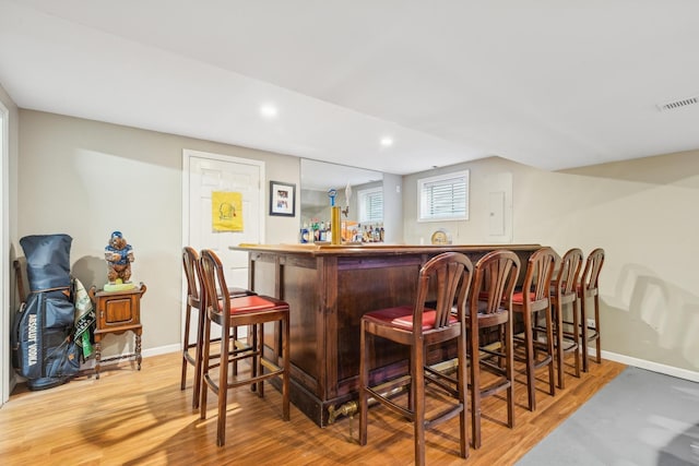 2851 Briarcliff Ln, Lake In The Hills, IL 60156 - bar with a dry bar, visible vents, light wood-type flooring, and baseboards