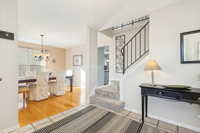 2851 Briarcliff Ln, Lake In The Hills, IL 60156 - tiled foyer entrance featuring stairs, a notable chandelier, and baseboards