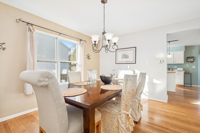 2851 Briarcliff Ln, Lake In The Hills, IL 60156 - dining area featuring a chandelier, baseboards, and light wood-style flooring
