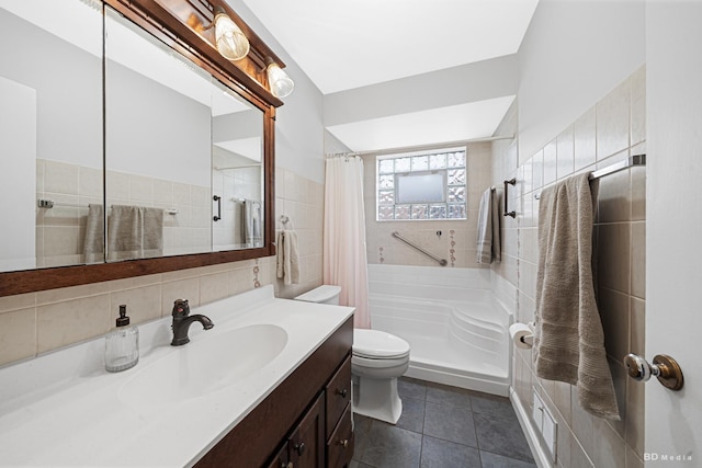 bathroom featuring tile walls, toilet, a shower with shower curtain, tile patterned flooring, and vanity