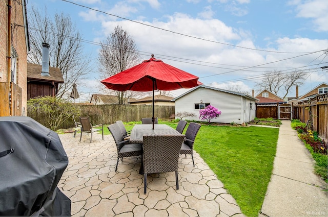 view of patio / terrace featuring a grill, an outdoor structure, and outdoor dining space