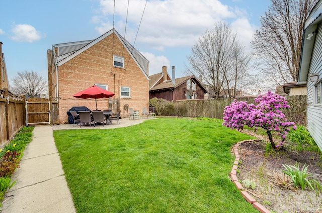 view of yard featuring a patio area and a gate