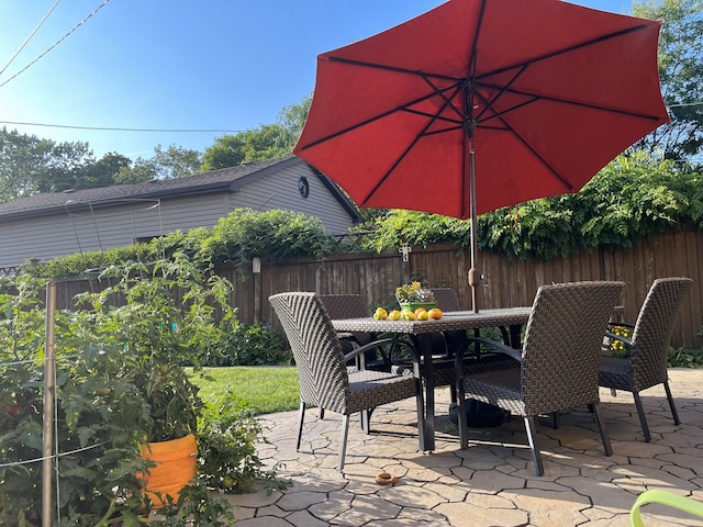 view of patio with fence and outdoor dining space