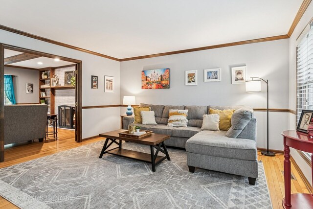 living area with crown molding, baseboards, and wood finished floors