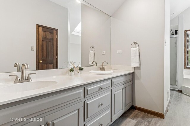 full bath featuring vaulted ceiling and a bath