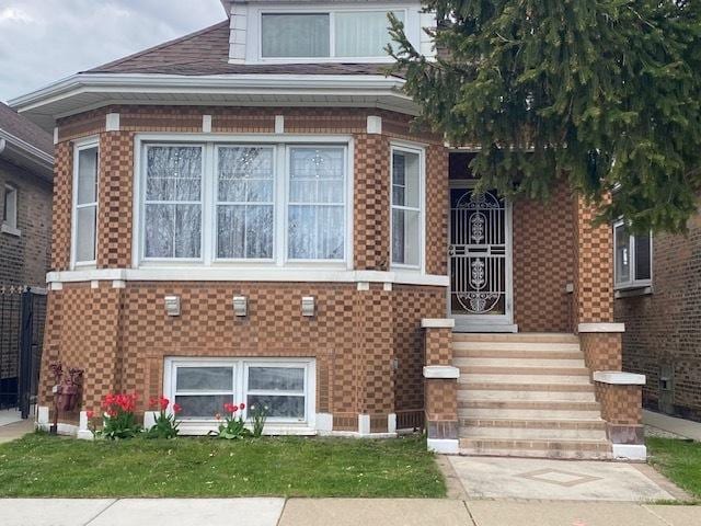 4816 S Harding Ave, Chicago, IL 60632 - bungalow-style home with a shingled roof and brick siding
