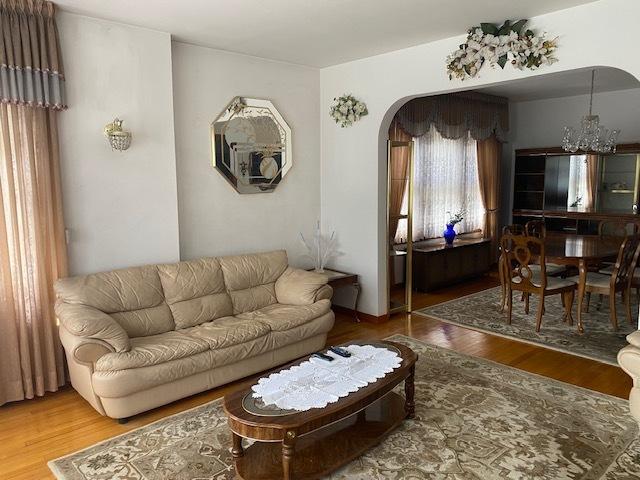 4816 S Harding Ave, Chicago, IL 60632 - living area with wood finished floors, an inviting chandelier, and arched walkways
