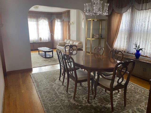 4816 S Harding Ave, Chicago, IL 60632 - dining space featuring baseboards, wood finished floors, and a notable chandelier