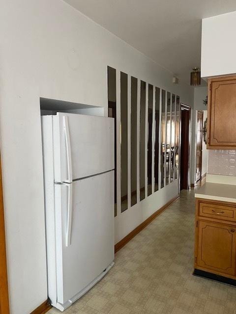 4816 S Harding Ave, Chicago, IL 60632 - kitchen featuring light floors, brown cabinets, light countertops, and freestanding refrigerator