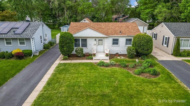 502 Everett Ave, Crystal Lake, IL 60014 - view of front of home with a front lawn, an outdoor structure, and asphalt driveway