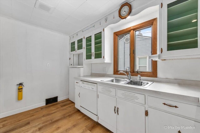 502 Everett Ave, Crystal Lake, IL 60014 - kitchen with white dishwasher, a sink, light countertops, white cabinets, and light wood finished floors
