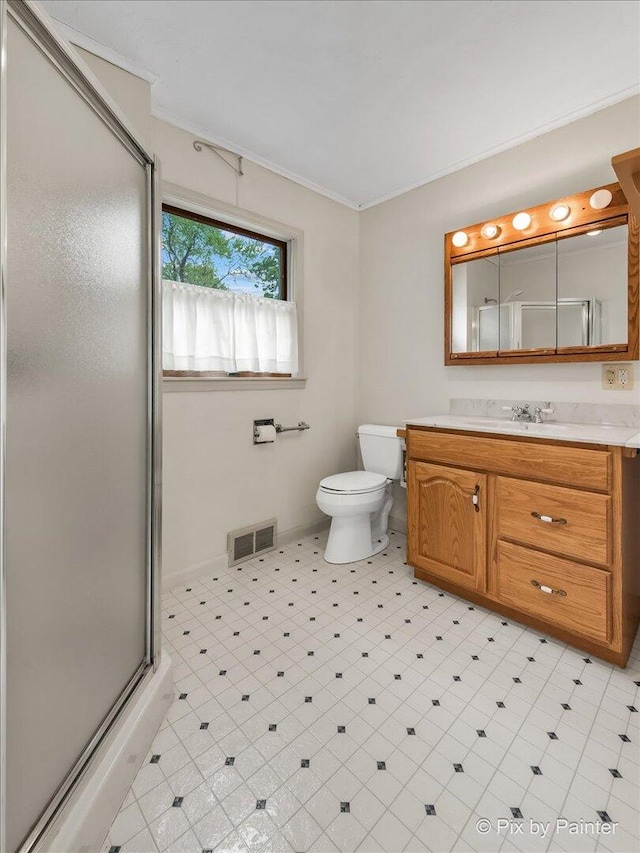 502 Everett Ave, Crystal Lake, IL 60014 - bathroom with vanity, a stall shower, toilet, crown molding, and tile patterned floors