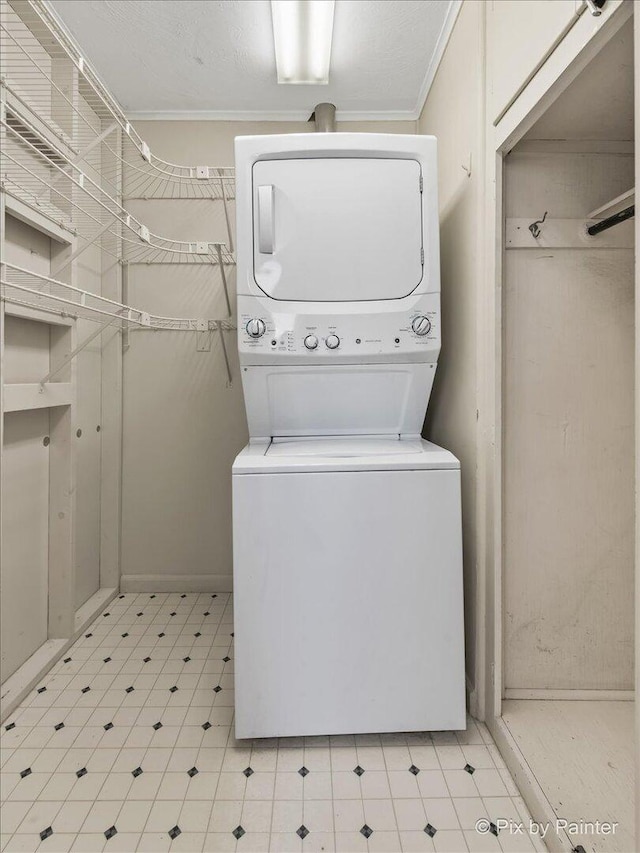 502 Everett Ave, Crystal Lake, IL 60014 - laundry area with stacked washer / dryer, light flooring, and crown molding