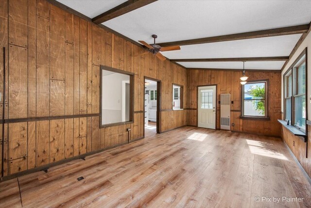 502 Everett Ave, Crystal Lake, IL 60014 - empty room featuring wooden walls, beam ceiling, wood finished floors, and a ceiling fan