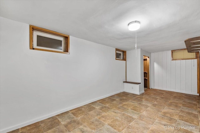 502 Everett Ave, Crystal Lake, IL 60014 - finished basement with baseboards, stone finish flooring, and wood walls