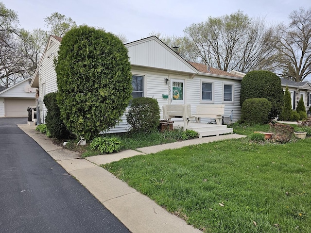 502 Everett Ave, Crystal Lake, IL 60014 - view of front of property with a front yard, board and batten siding, and an outdoor structure