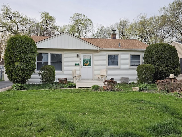 502 Everett Ave, Crystal Lake, IL 60014 - view of front facade featuring a front lawn, a shingled roof, and a chimney
