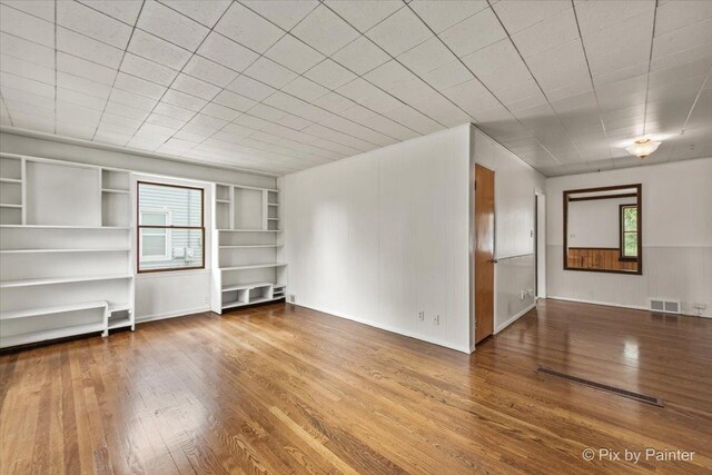 502 Everett Ave, Crystal Lake, IL 60014 - unfurnished living room with wood finished floors, built in features, and baseboards