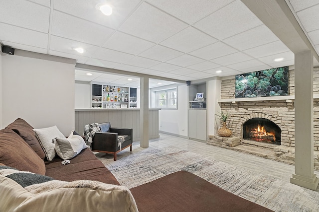 living area featuring a fireplace, recessed lighting, wood finished floors, and a paneled ceiling