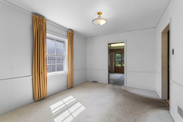 spare room featuring carpet floors and visible vents