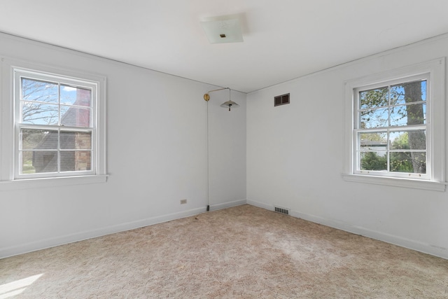unfurnished room featuring visible vents, carpet flooring, and baseboards