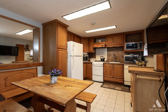 kitchen with brown cabinets, open shelves, a sink, white appliances, and backsplash