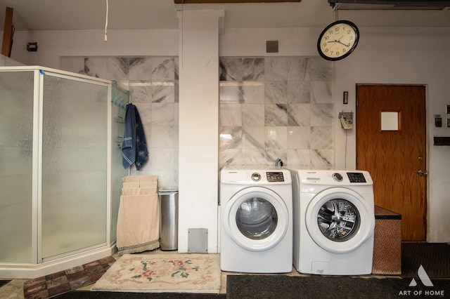 washroom featuring washer and dryer and laundry area