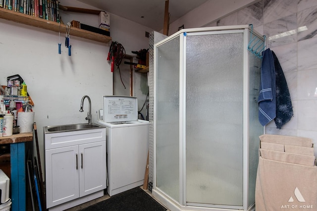 washroom featuring washer / clothes dryer, laundry area, and a sink