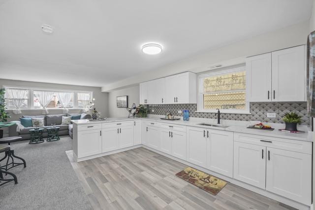 2716 N 73rd Ave, Elmwood Park, IL 60707 - kitchen featuring open floor plan, light countertops, white cabinets, and a sink