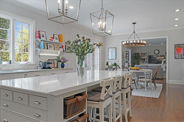 kitchen featuring recessed lighting, light countertops, a chandelier, tasteful backsplash, and dark wood finished floors