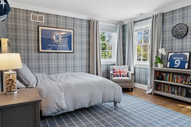 bedroom featuring crown molding, wallpapered walls, and visible vents
