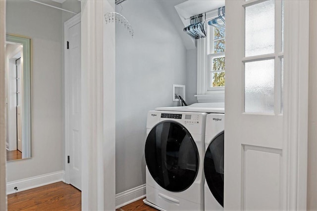 laundry room with washer and dryer, laundry area, baseboards, and wood finished floors