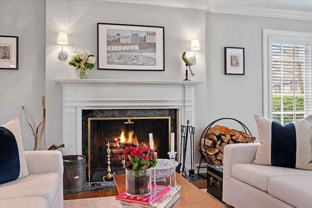 living area with crown molding, wood finished floors, and a high end fireplace