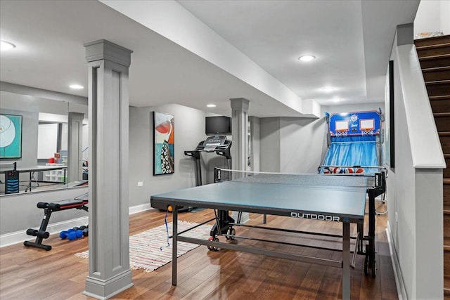 recreation room featuring ornate columns, recessed lighting, baseboards, and wood finished floors