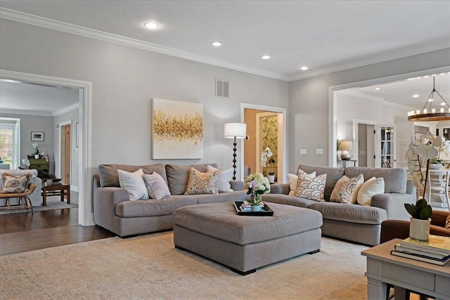 living room with a chandelier, recessed lighting, wood finished floors, and visible vents
