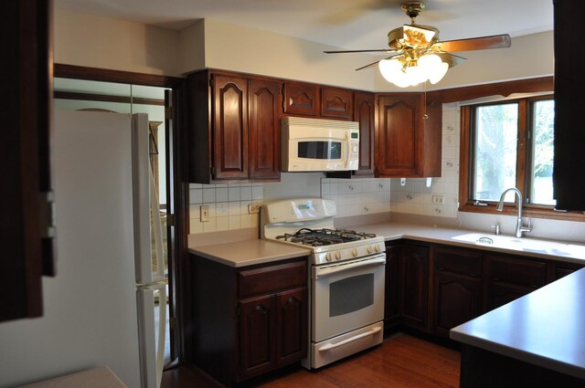 1272 N Scarlet Dr, Addison, IL 60101 - kitchen featuring white appliances, a sink, light countertops, decorative backsplash, and dark wood finished floors