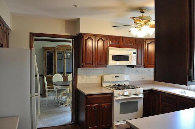 1272 N Scarlet Dr, Addison, IL 60101 - kitchen featuring freestanding refrigerator, light countertops, dark wood-type flooring, and dark brown cabinets