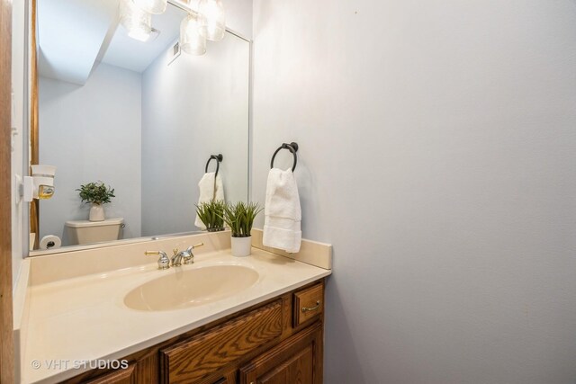bathroom with toilet and vanity